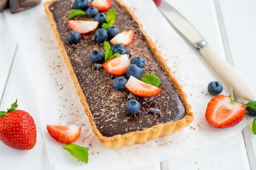 Chocolate cream tart with fresh blueberries and strawberries on top, procured by Private Chef in Denver